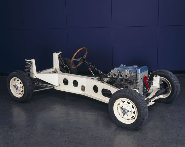 The backbone of this Lotus chassis consists of a very strong deep-sectioned box girder of welded steel, with forks at each end to carry the independent coil spring and wishbone suspension. A light and streamlined glass-fibre two-seater body is mounted onto the chassis. The car's engine produces 115 bhp at 6000 rpm. It has a four-speed syncromesh gearbox, rack and pinion steering and is fitted with Girling disc brakes on the front and rear wheels. Colin Chapman established Lotus Cars in 1951, and this model, the Elan, first appeared in 1962. (Picture and caption text courtesy of Wikipedia).