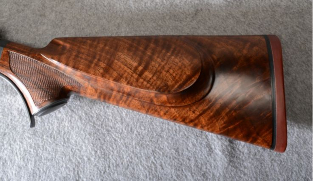 The wood used on this rifle is very nicely grained with pretty figure. The rubber pad is for non-slip as there is no need for a recoil pad on a .218 Mashburn Bee. (Picture courtesy Cabela's).