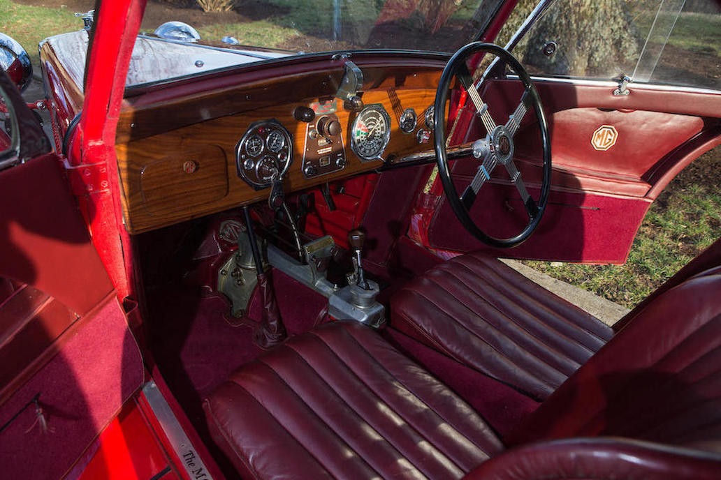 An enthusiast's interior. The mixing of luxurious wood for the dashboard and yet with the naked top of the gearbox visible is a curious mix of refinement and race track practicality. (Picture courtesy Bonhams).