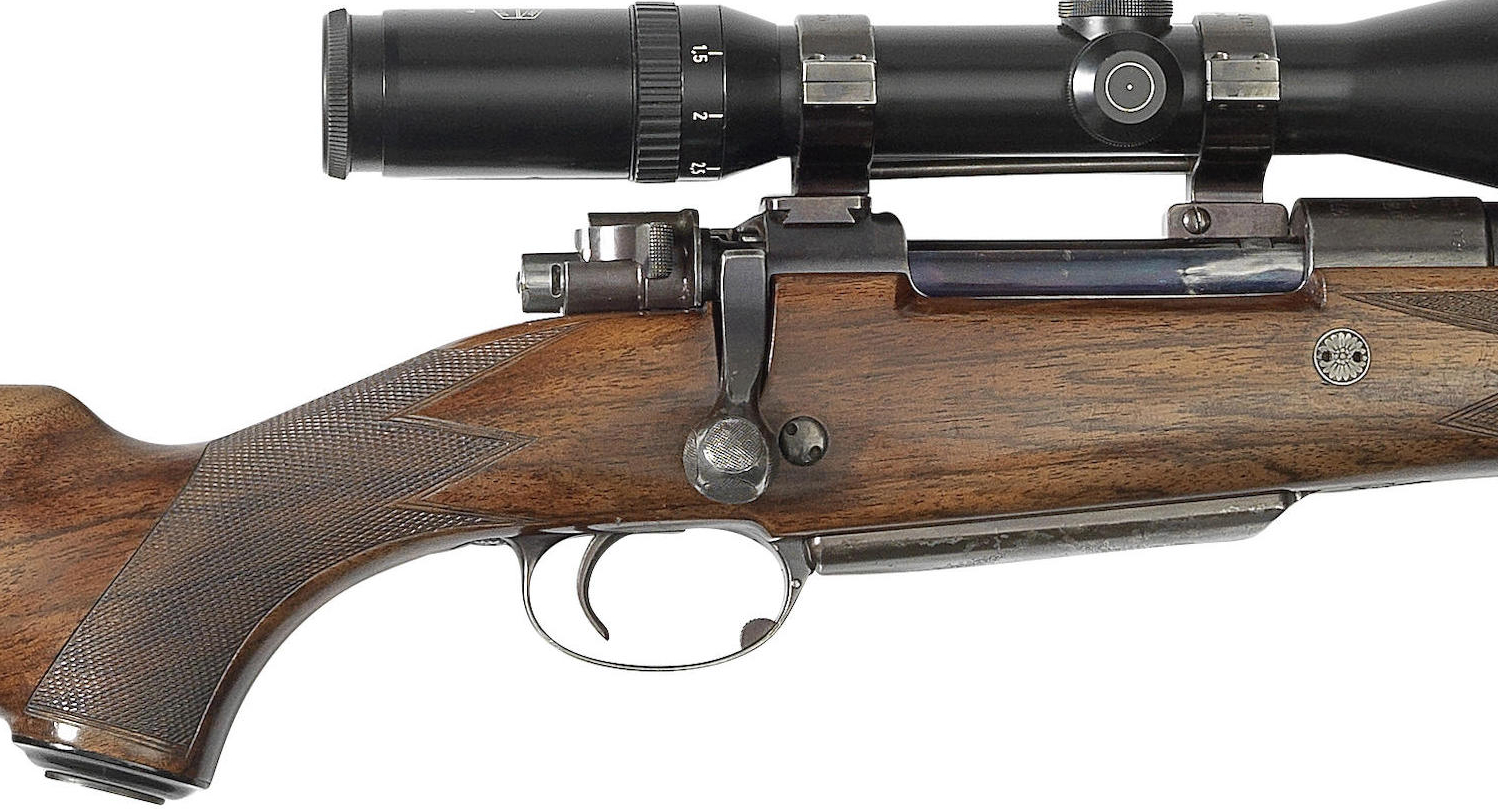 The safety catch on this rifle appears to have been modified to a push forward type so as to clear the low mounted rifle-scope.