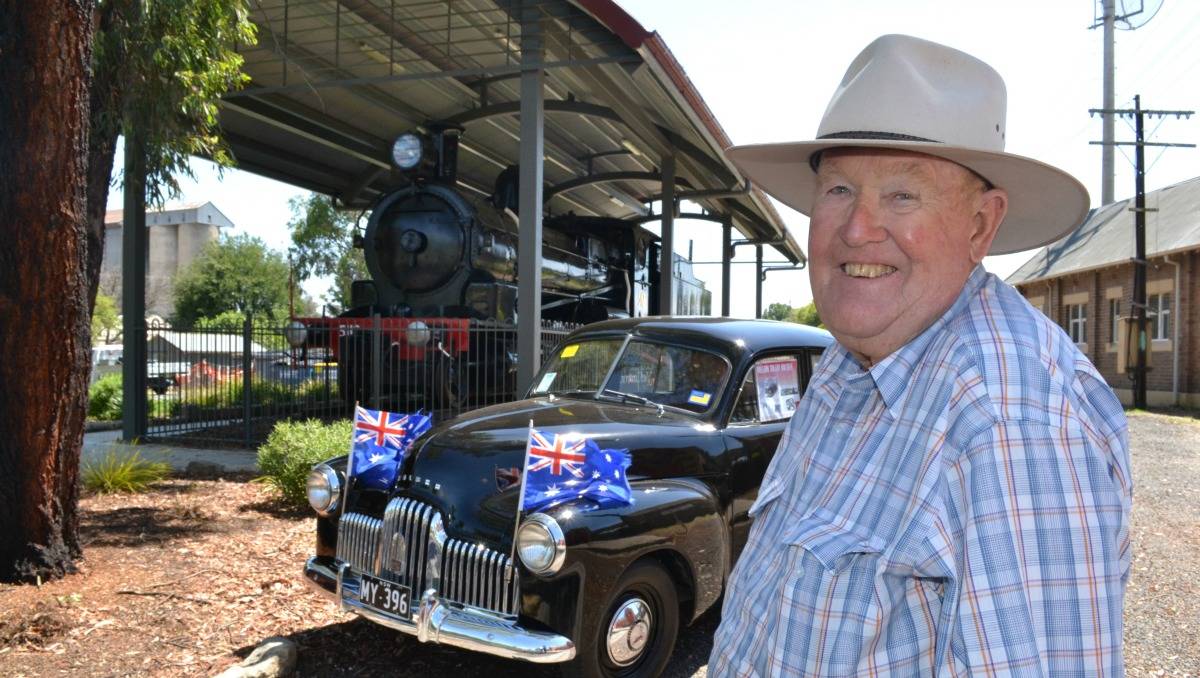 Charlie McCarron with the oldest Holden in his collection; a 1948 model and the 46th ever made. The locomotive in the background was driven by former Australian Prime Minister Ben Chifley. (Picture courtesy westernadvocate.com.au).