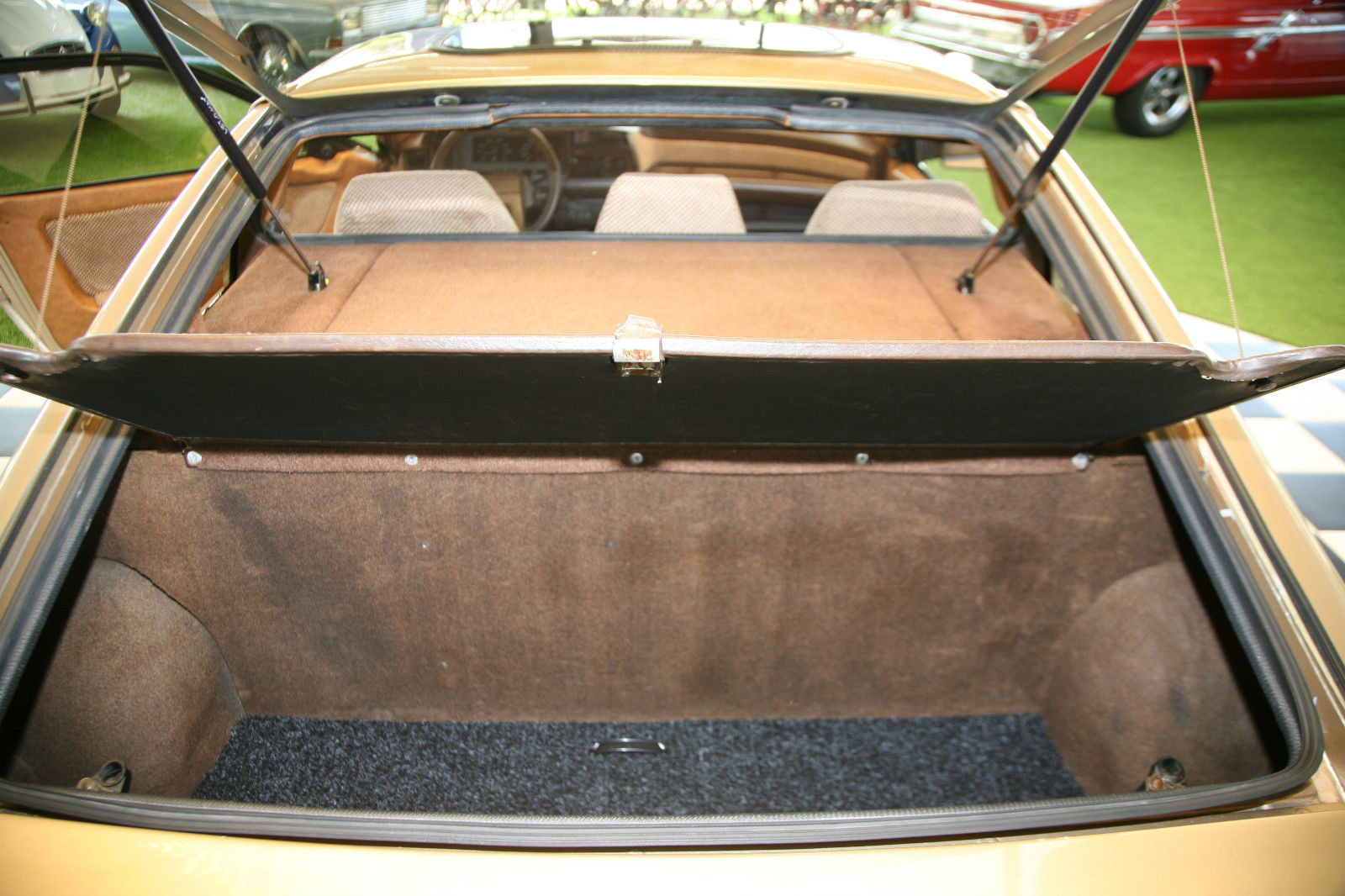 Luggage space is modest. The mid-engine sits in the compartment ahead of the luggage area.