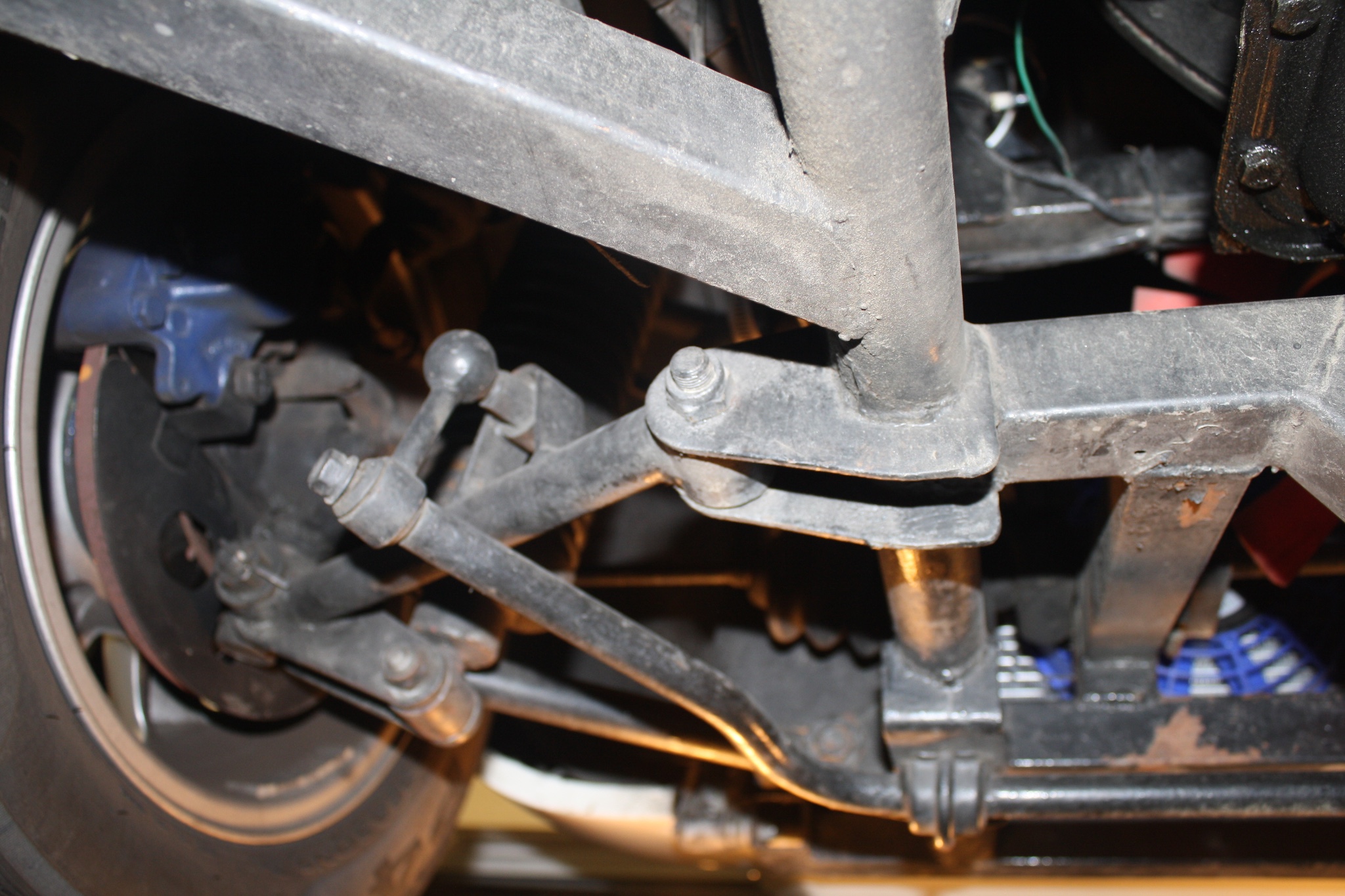 Front suspension view showing the Triumph TR6 11" disc brake and giving an idea of chassis construction.