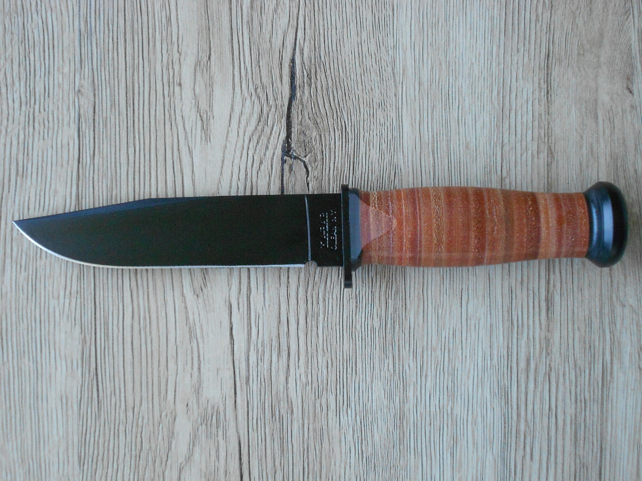 The Ka-Bar US Navy Mark 1 is fairly small with a blade length of 5.125" and an overall length of 9.375". Design is simple, straight, and practical.