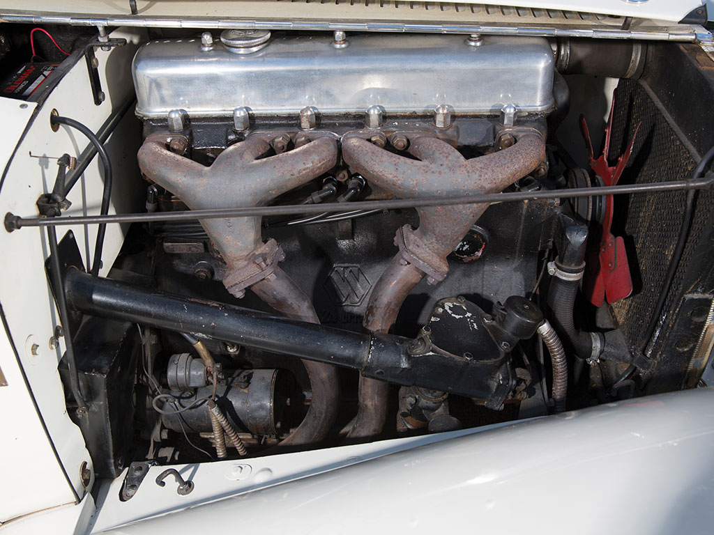 The 2½ liter engine looks impressive under the hood. The twin SU carburettors are bolted directly to the specially designed William Heynes and Harry Weslake cylinder head. The exhaust manifold shows attention to tuning and gas flow.